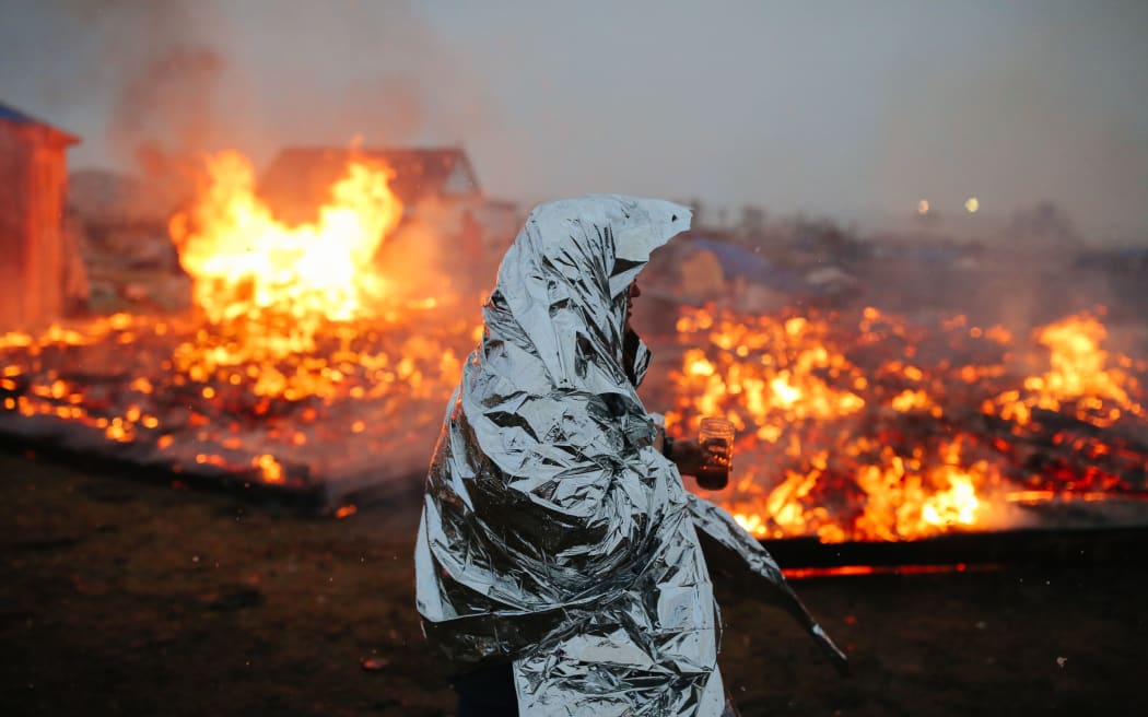 Campers set structures on fire in preparation of the Army Corp's 2pm deadline to leave the Oceti Sakowin protest camp.