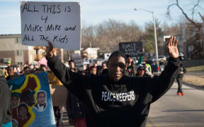Demonstrators remember Michael Brown with a Martin Luther King Jr Day march on January 19, 2015.