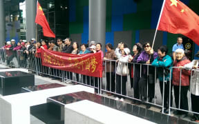 Supporters waving Chinese flags were metres away from a small group of Falun Gong protestors.