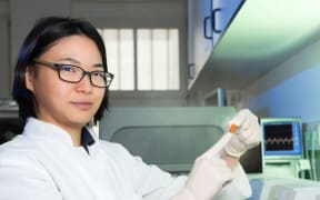 Female researcher with cryosample