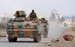 Turkey-backed-opposition fighters advance on the western outskirts of the northern Syrian city of al-Bab.