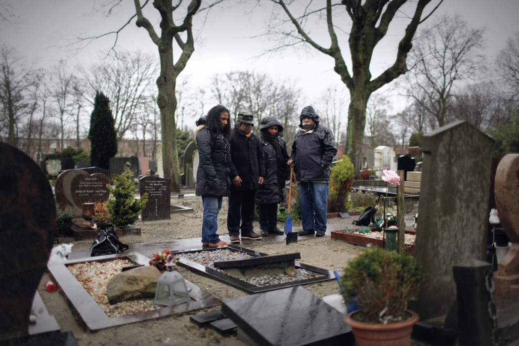 A family of West Papuan refugees grieving at the grave of Seth Jafeth Rumkorem in the Hague.