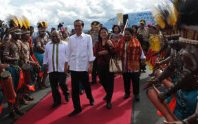 The Governor of Papua Province, Lukas Enembe, (far left), welcomes the Indonesian President Joko Widodo. In 2014.