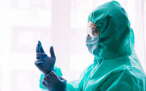 Man doctor or scientist waring protective suit, and face mask