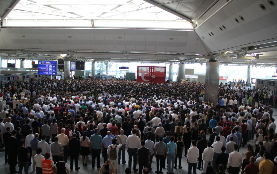 People attend a commemorative ceremony, held for the victims of the Istanbul Airport terrorist attack at International arrivals terminal in Istanbul, Turkey on June 30, 2016.