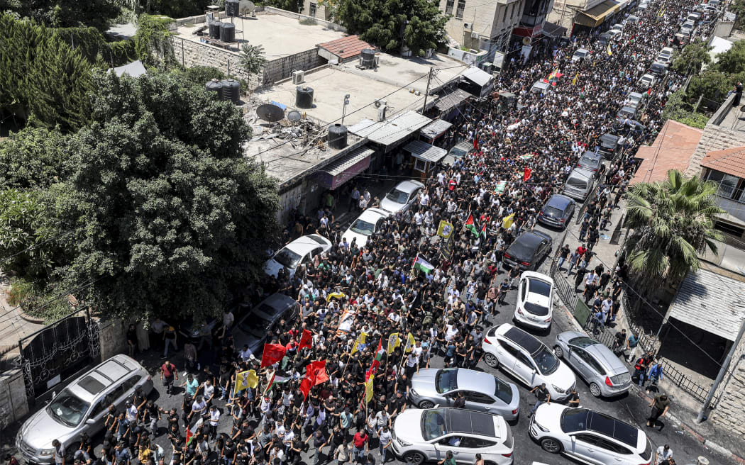 Mourners carry the bodies of Palestinians killed in clashes the previous day in the Israeli military operation during the funeral in Jenin in the occupied West Bank on 5 July 2023.