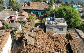 An aerial picture shows damaged buildings in Jajarkot district on November 4, 2023, following an overnight 5.6-magnitude earthquake. At least 132 people were killed in an overnight earthquake of 5.6-magnitude that struck a remote pocket of Nepal, officials said on November 4, as security forces rushed to assist with rescue efforts. (Photo by Harihar SINGH RATHOR / AFP)