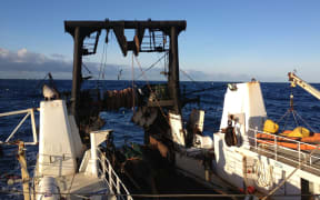 A Sealord fishing boat at sea.