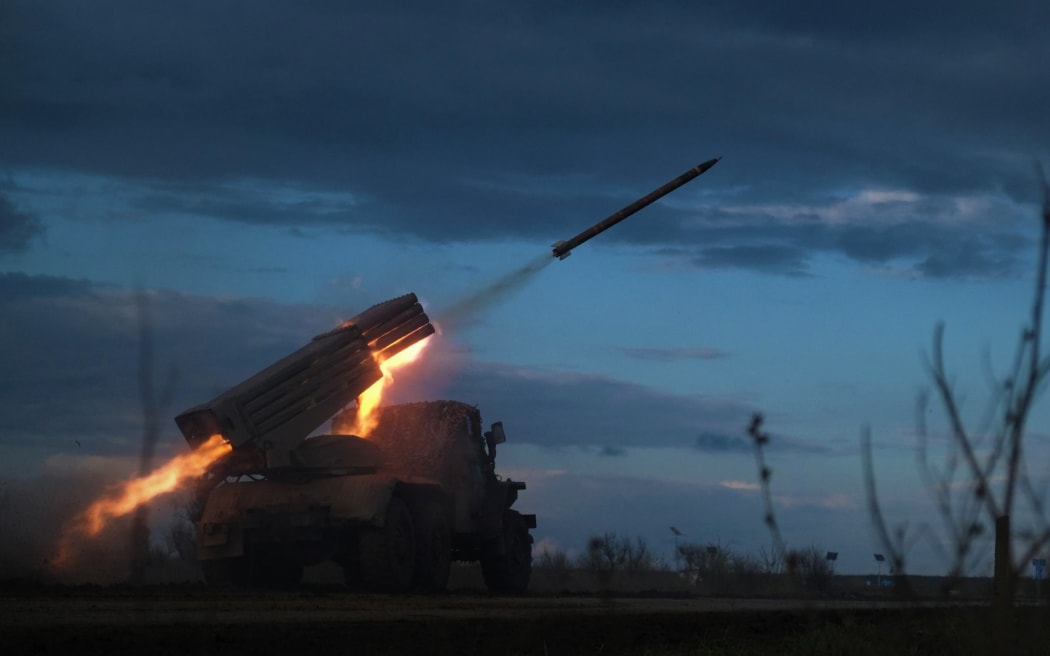 A BM-21 Grad multiple rocket launcher fires towards Russian positions on the frontline near Bakhmut, Donetsk region, on April 23, 2023, amid the Russian invasion on Ukraine. (Photo by Sergey SHESTAK / AFP)