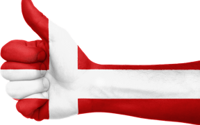 A thumbs up painted in the colours of the flag of Denmark