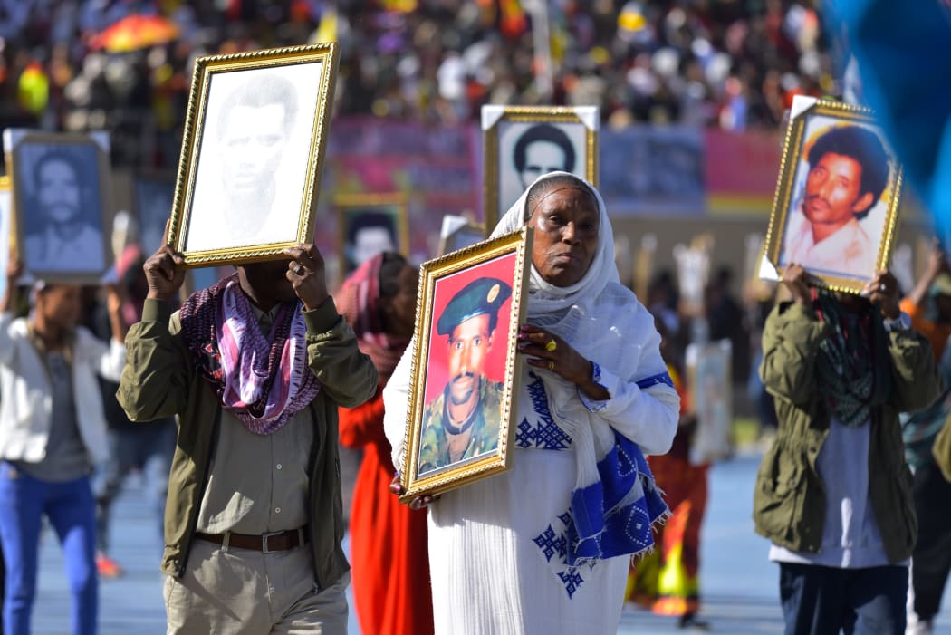 Paraders carry photos of their deceased relatives during the 45th anniversary of the "Armed Struggle of the Peoples of Tigray" on February 19, 2020, in Mekelle.