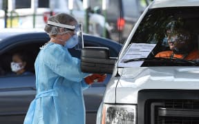 People are tested for Covid-19 at a drive through testing site sponsored by the city at Camping World Stadium on July 8, 2020 in Orlando, Florida.