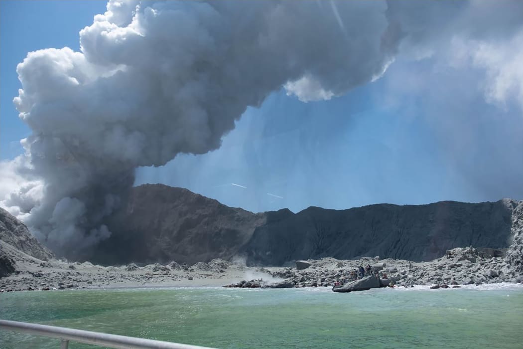 This handout photograph courtesy of Michael Schade shows the volcano on New Zealand's White Island spewing steam and ash minutes following an eruption on December 9, 2019.