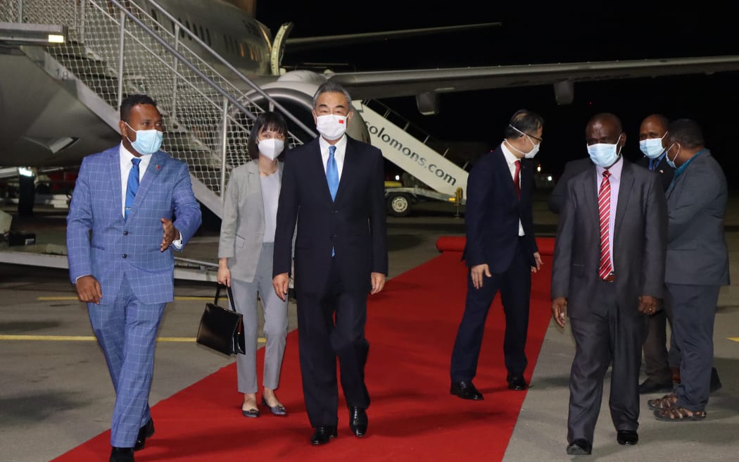 Solomon Island's Foreign Minister Jeremiah Manele escorting Chinese Foreign Minister Wang Yi upon his arrival at the Henderson International Airport in Honiara, on 25 May, 2022.
