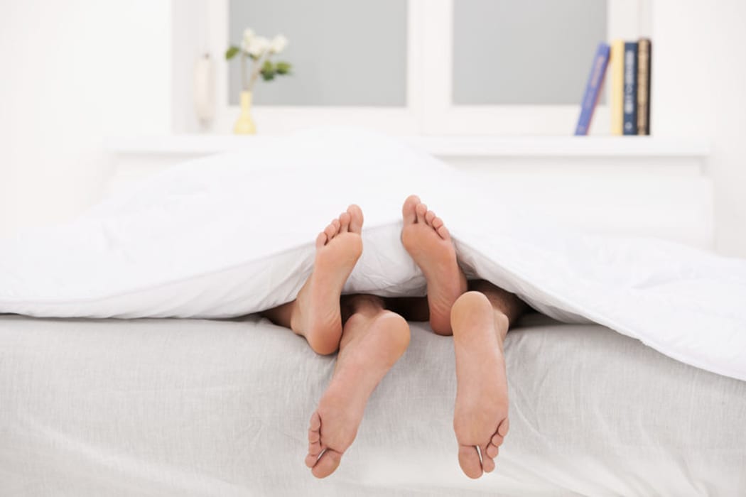 Bed with couple's feet