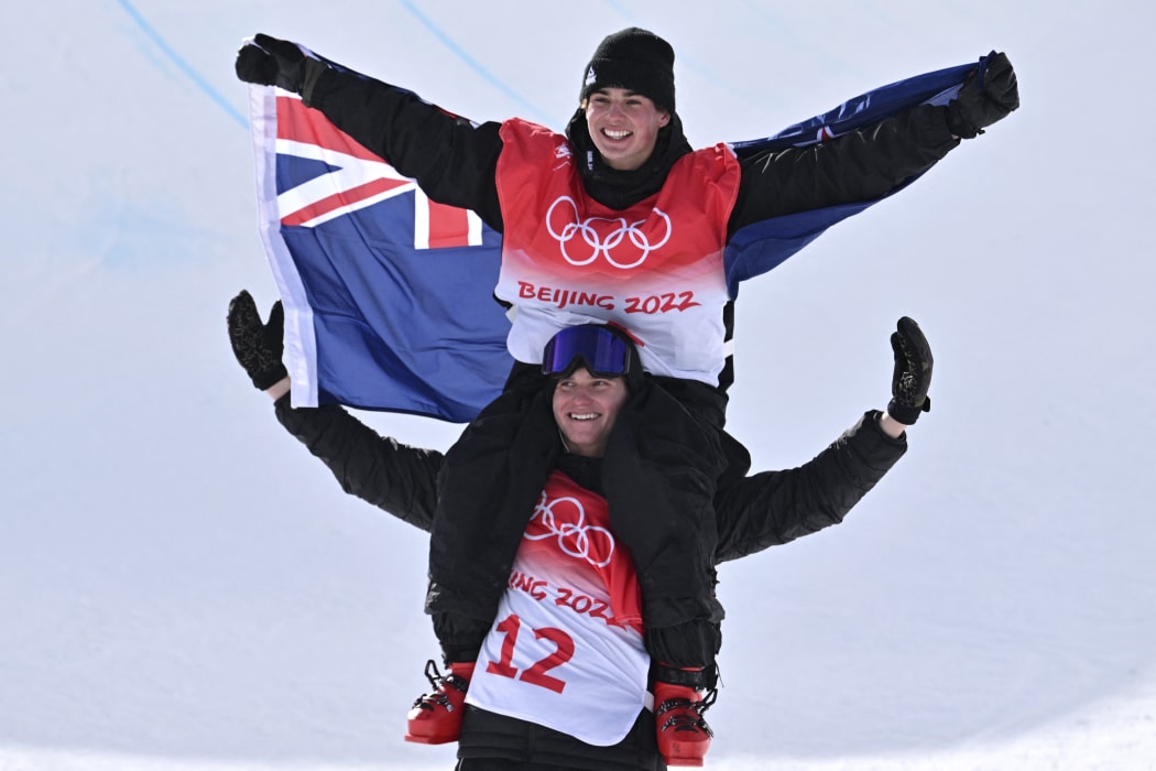 Gold medallist New Zealand's Nico Porteous is carried by his brother Miguel Porteous after the freestyle skiing men's freeski halfpipe final run during the Beijing 2022 Winter Olympic Games on February 19, 2022.