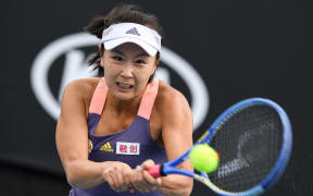 China's Shuai Peng hits a return against Japan's Nao Hibino during their women's singles match on day two of the Australian Open tennis tournament in Melbourne on January 21, 2020.