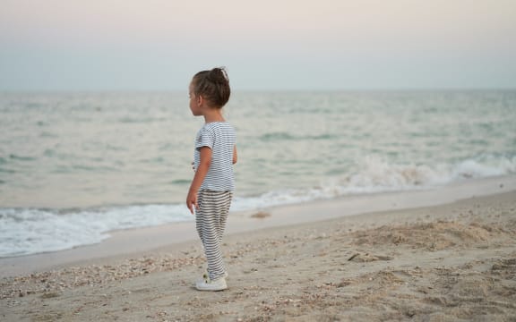 Child playing sand beach