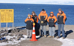 Winter base staff at the cone, with their backs to an invisible New Zealand..
