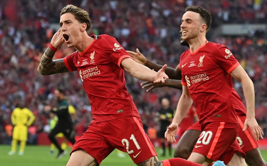 Liverpool's Greek defender Kostas Simikas (L) celebrates with teammates after scoring a goal during the penalty session of the English FA Cup Final football match between Chelsea and Liverpool at Wembley Stadium in London on May 14, 2022.  - Liverpool beat Chelsea on penalties to win the FA Cup Final.  (Photo by Glynn Kirk / AFP) / Not for marketing or advertising use / Restricted for editorial use