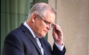 This file photo taken on March 22, 2020 shows Australia's Prime Minister Scott Morrison reacting during a press conference at Australia's Parliament House in Canberra.