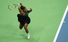 Serena Williams of the US hits a return to Naomi Osaka of Japan during their 2018 US Open women's singles final match.