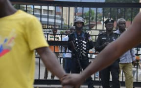 People hold hands to barricade the protesters from the Nigerian Police force as they march at Alausa Secretariat in Ikeja, Lagos State.