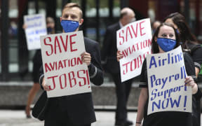 Airline industry workers hold signs during a protest in Federal Plaza in Chicago, Illinois, on September 9, 2020. - Other protests where held in