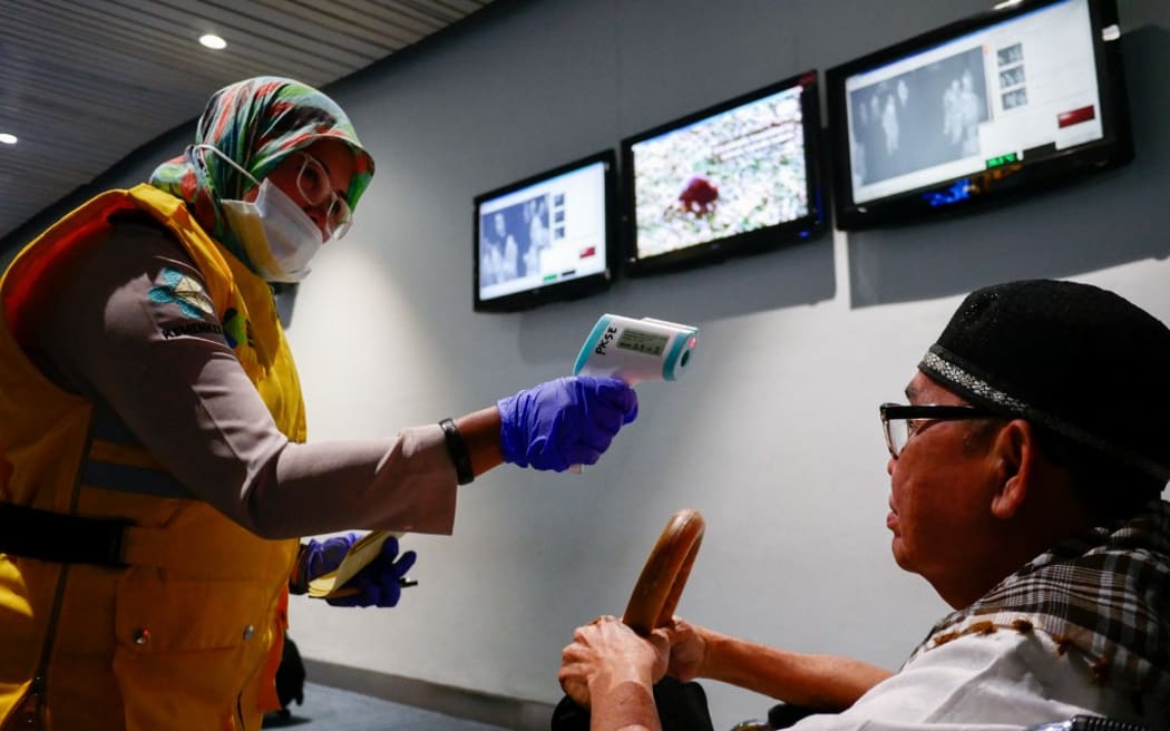 TANGERANG, INDONESIA - MAY 15: Health officer uses a thermal head to detect a monkeypox virus on arriving passengers at Soekarno-Hatta International Airport in Tangerang near Jakarta, Indonesia on May 15, 2019. Monkeypox is an infectious disease by monkeypox virus endemic from parts of Central and Westerns Africa that make humans lesions, fever, muscle aches, and chills. Anton Raharjo / Anadolu Agency (Photo by Anton Raharjo / ANADOLU AGENCY / Anadolu Agency via AFP)