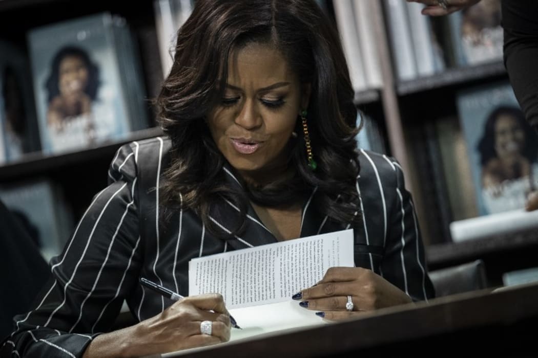 Former U.S. First Lady Michelle Obama signs copies of her new book 'Becoming' during a book signing event in New York City. The memoir has sold more than 2 million copies in all formats in North America during its first 15 days on the market.