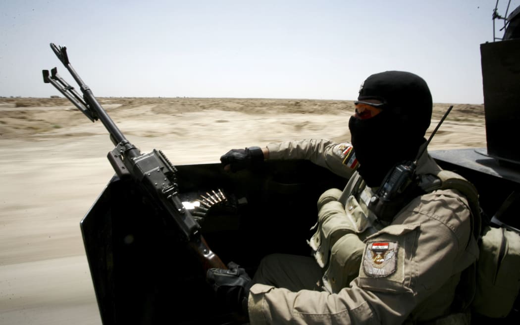 An Iraqi government soldier patrolling in the Jurf al-Sakher area, some 50km south of Baghdad.