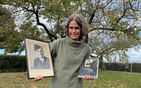 Wendy St George with a photo of her uncle Edward Saywell and the book she has written about his service in World War II.
