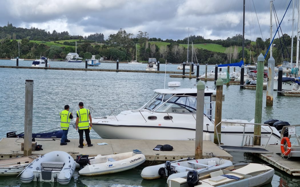 Maritime NZ officials at Port Opua boatyard assess the motorboat that crashed into a ferry in the Bay of Islands on Thursday.