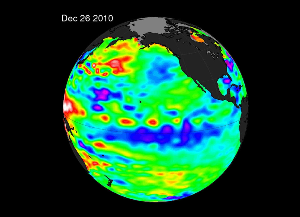This NAS enhanced satellite illustration from December 26, 2010 shows La Niña by the large (blue and purple) water stretching from the eastern to the central Pacific Ocean, reflecting lower than normal sea surface heights.