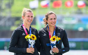 Silver medallists New Zealand's Brooke Donoghue and Hannah Osborne celebrate on the podium following the women's double sculls final during the Tokyo 2020 Olympic Games at the Sea Forest Waterway in Tokyo on July 28, 2021. (Photo by Charly TRIBALLEAU / AFP)