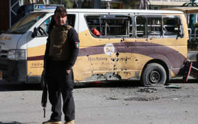 An Afghan security official inspects the scene of the rocket attacks in Kabul.