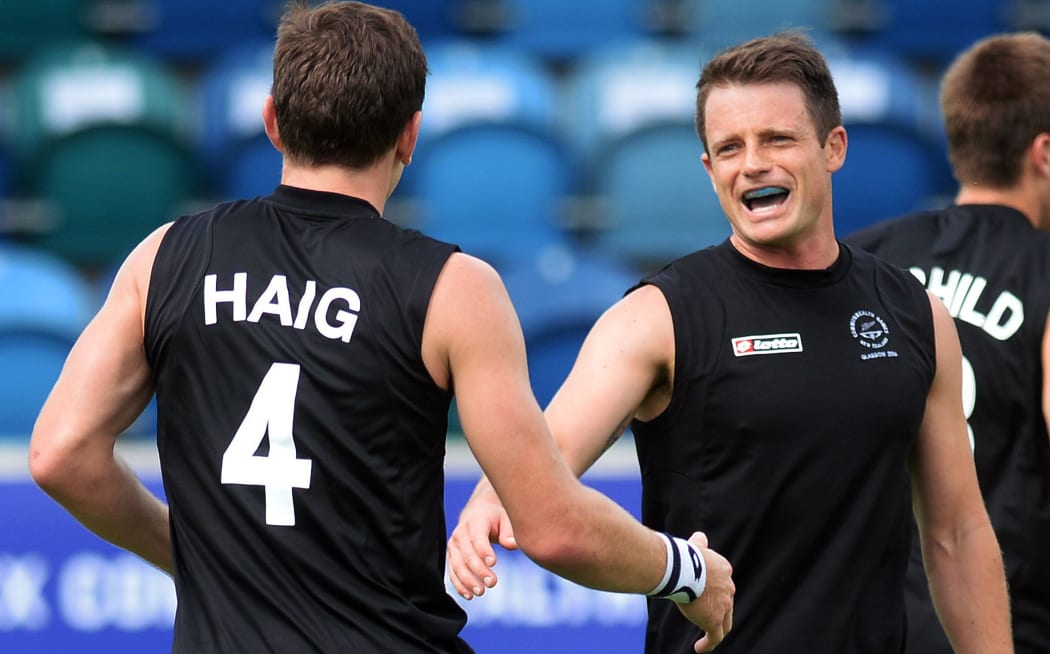 Nick Haig celebrates a goal with his New Zealand team-mate Shea McAleese.