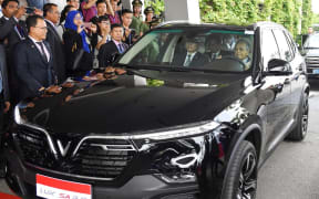 Malaysia's Prime Minister Mahathir Mohamad (R) drives a VinFast luxury SUV manufactured by Vietnam's first homegrown car manufacturer VinFast in Hanoi.