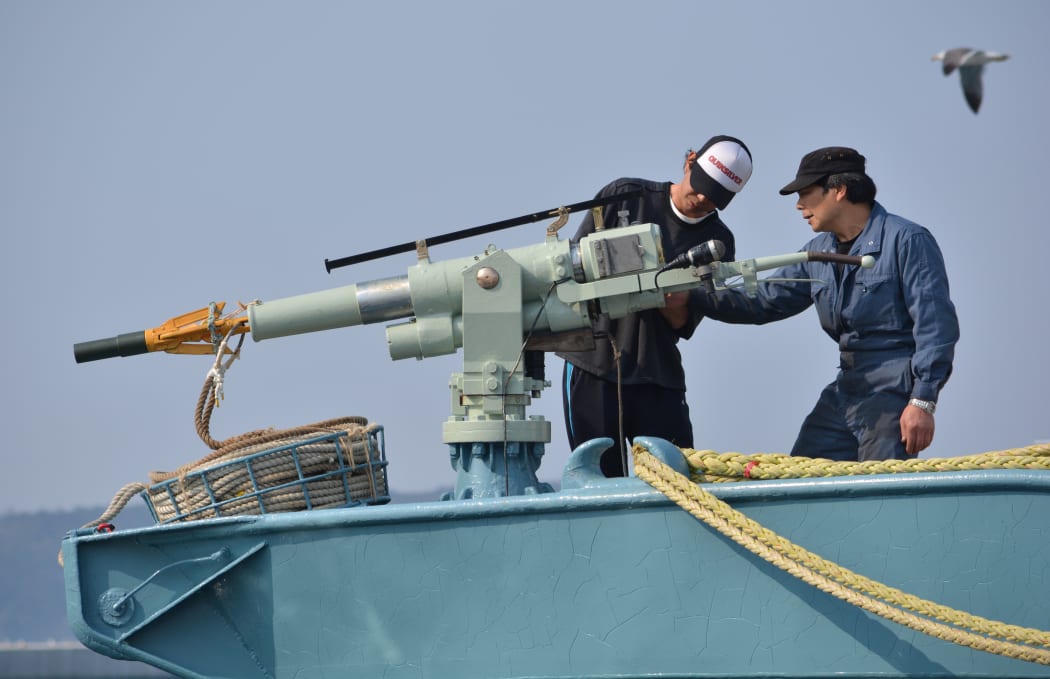 Crew of a whaling ship check a whaling gun or harpoon before departure at Ayukawa port in Ishinomaki City on April 26, 2014.. AFP PHOTO / KAZUHIRO NOGI