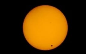 Venus is seen tracking across the surface of the sun.