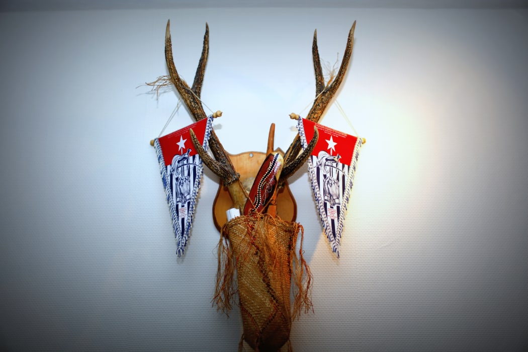 Traditional accessories from West Papua alongside the outlawed West Papuan independence flag, the Morning Star.