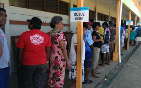 Voters in Fiji's election queue at John Wesley College, Suva.