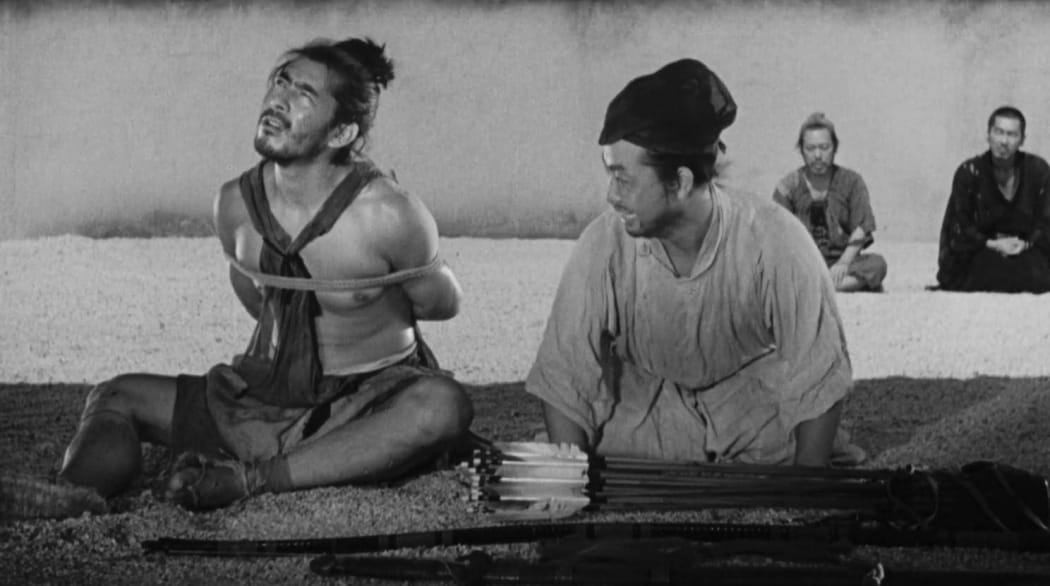 Still frame from Akira Kurosawa's 1950 film Rashomon featuring Toshiro Mifune as a bandit accused of murder