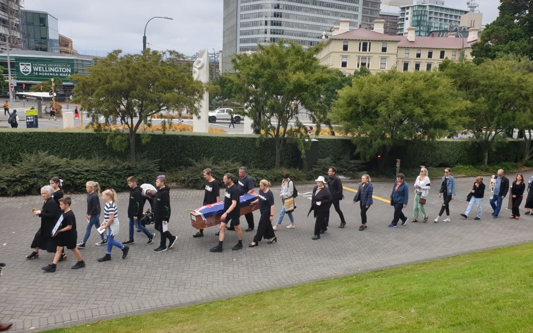 A mock funeral led by Julian and Camilla Cox who cycled from Dunedin to Wellington. Pictured outside Parliament.