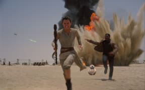 Daisy Ridley and John Boyega escape an attack in Star Wars: The Force Awakens (Abrams, 2015).