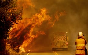 A fire truck drives through flames as the Hennessey fire continues to rage out of control near Lake Berryessa in Napa, California on 18 August, 2020.