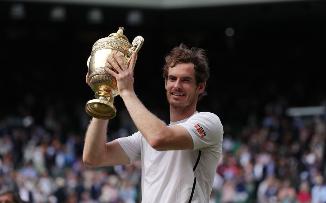 Andy Murray poses with the winner's trophy after victory over Canada's Milos Raonic.