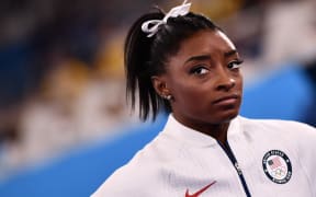 USA's Simone Biles reacts during the artistic gymnastics women's team final during the Tokyo 2020 Olympic Games at the Ariake Gymnastics Centre in Tokyo on July 27, 2021.