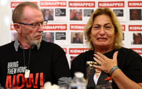 Orit Meir (R), mother of Almog Meir, cries next to Thomas Hand, father of Emily Hand, during a press conference by families of hostages held by Palestinian militant group Hamas in Gaza, at the embassy of Israel in London on November 20, 2023. Fighting raged in Gaza, more than six weeks after a shock Hamas attack sparked an air and ground offensive by Israel, which has vowed to destroy the Palestinian militant group. In Gaza, around 13,000 people, more than 5,500 of them children, have been killed in the conflict, officials in the Hamas-run territory have said. About 1,200 people, mostly civilians, were killed in Israel during the October 7 attack and around 240 taken hostage, according to Israeli officials. (Photo by HENRY NICHOLLS / AFP)