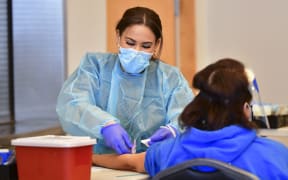 A phlebotomist draws blood during a Covid-19 antibody testing site on February 17, 2021 in Pico Rivera, California.